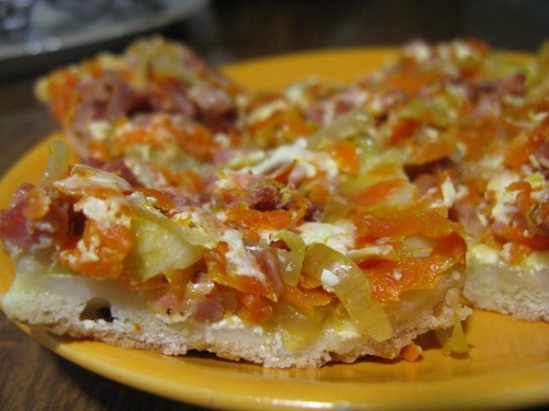 Pizza pie with vegetables and sour cream