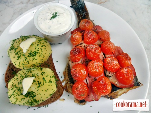 Halibut baked under brisket and cherry tomatoes with white sauce