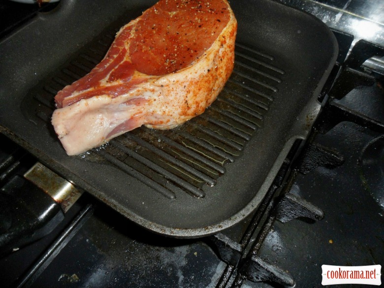 Steak from pork loin on the bone and cream sauce with demi glas.