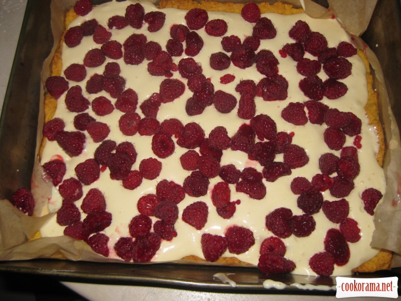 Cake with raspberries under white pudding