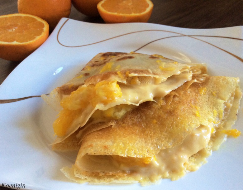 Pancakes with butter cream and oranges